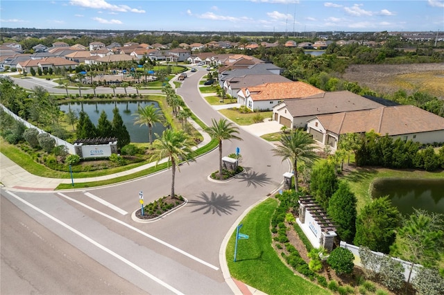 birds eye view of property with a water view and a residential view