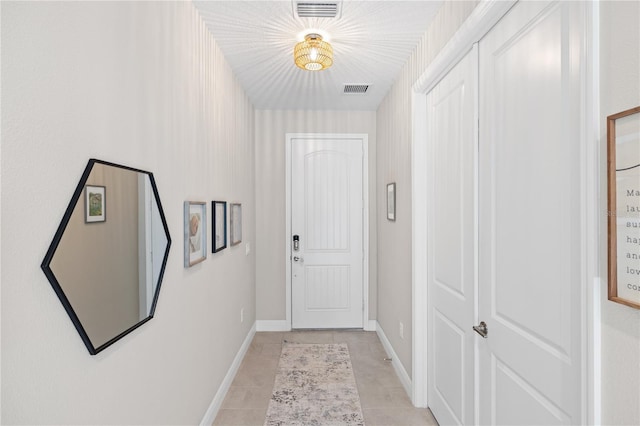 doorway to outside featuring light tile patterned floors, baseboards, and visible vents