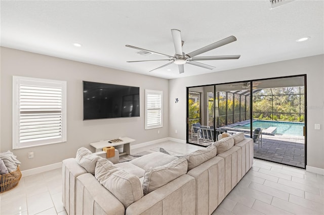 living room with ceiling fan, recessed lighting, a sunroom, and baseboards