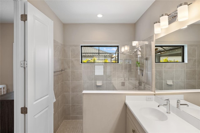 full bathroom with walk in shower and vanity