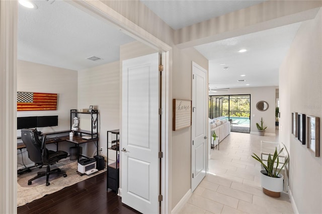 office space featuring recessed lighting, visible vents, a sunroom, wood finished floors, and baseboards