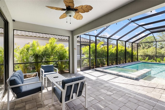 view of swimming pool featuring a patio area, glass enclosure, outdoor lounge area, and a ceiling fan