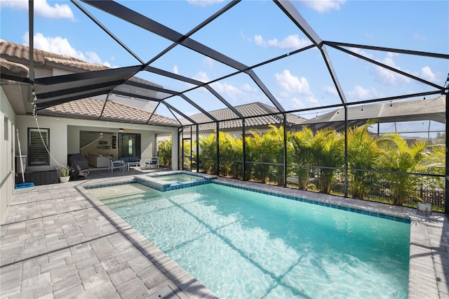 view of pool with a patio, a lanai, and a pool with connected hot tub