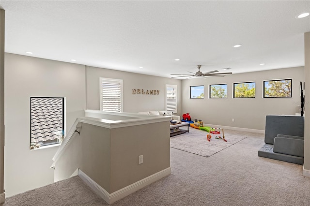 rec room with baseboards, recessed lighting, and light colored carpet