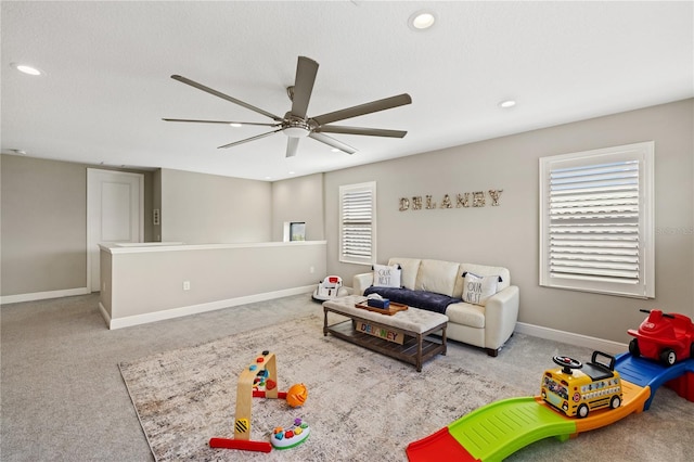 carpeted living area featuring recessed lighting, a ceiling fan, and baseboards