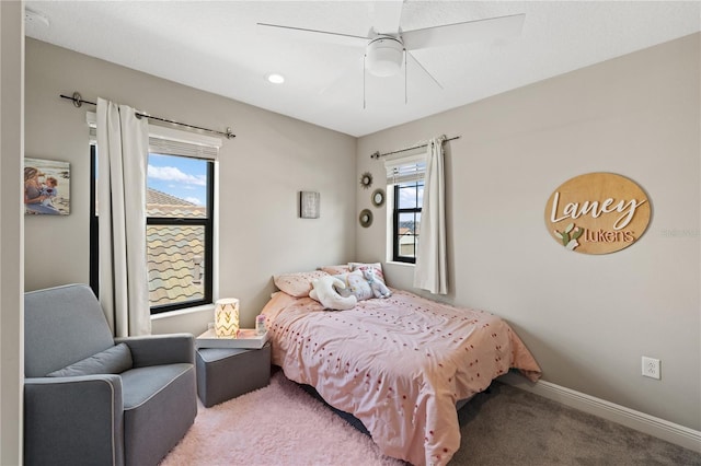 bedroom with carpet, multiple windows, ceiling fan, and baseboards