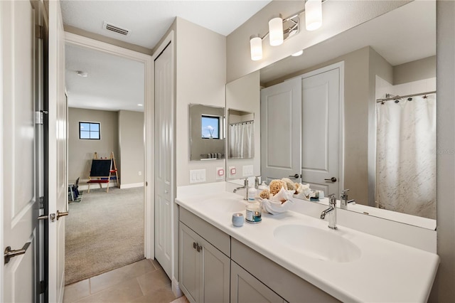 full bathroom with tile patterned flooring, visible vents, a sink, and double vanity