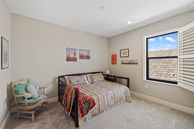 carpeted bedroom featuring a textured ceiling, recessed lighting, and baseboards