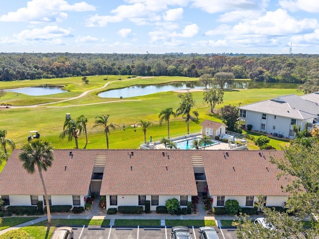 drone / aerial view featuring view of golf course and a water view