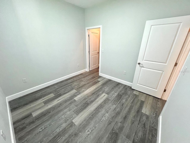 unfurnished bedroom featuring baseboards and wood finished floors