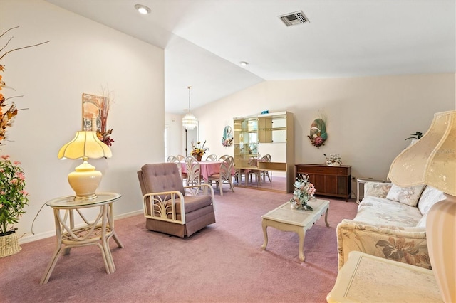 carpeted living room featuring visible vents, baseboards, and lofted ceiling