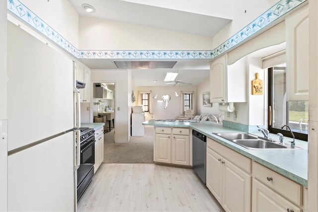 kitchen featuring gas stove, a peninsula, a sink, light countertops, and stainless steel dishwasher