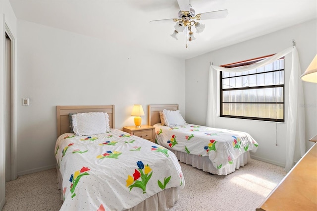 bedroom featuring baseboards and ceiling fan