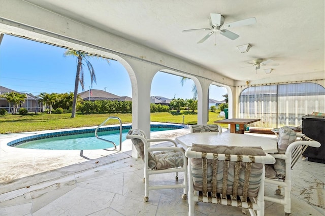 pool with a lawn, a patio, and ceiling fan