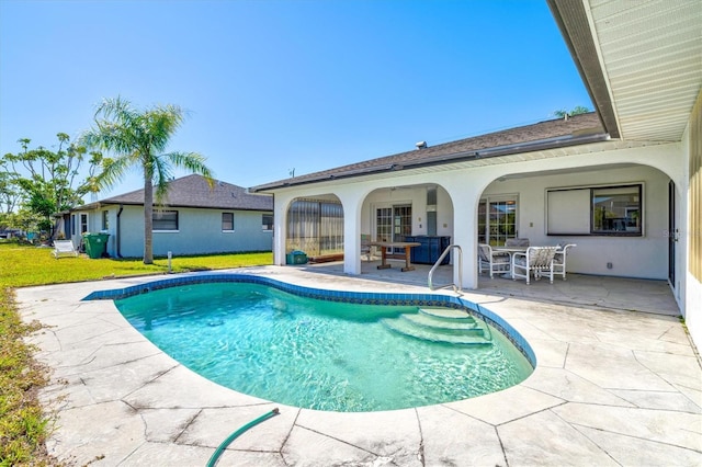 outdoor pool featuring a yard and a patio area