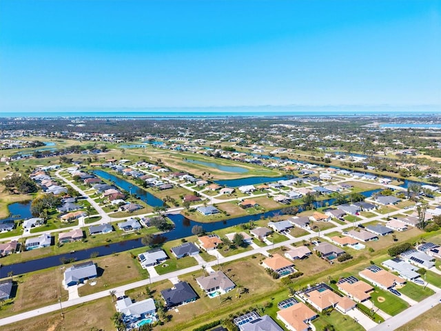 birds eye view of property with a residential view and a water view