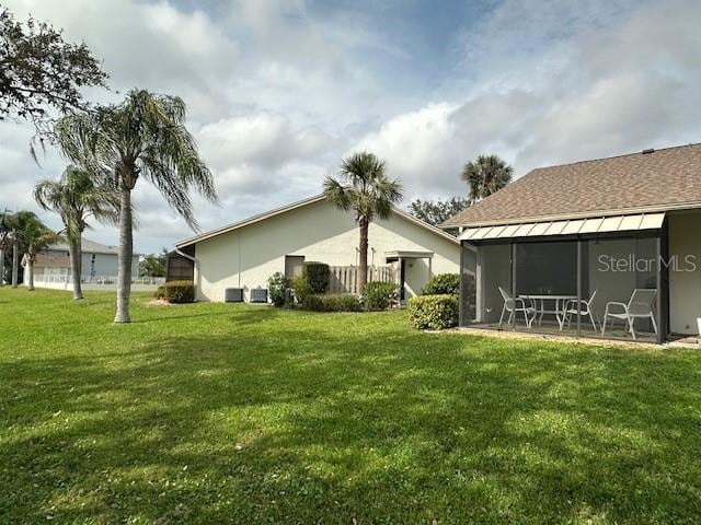 rear view of property featuring a lawn