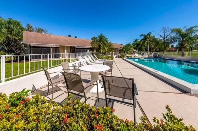 pool featuring a patio area and fence