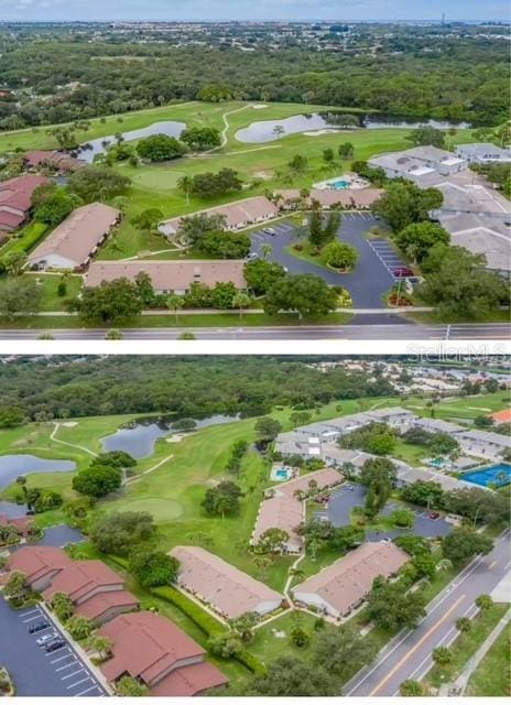 drone / aerial view with a residential view, a water view, and golf course view