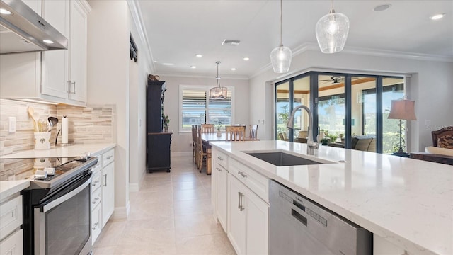 kitchen featuring range hood, visible vents, appliances with stainless steel finishes, ornamental molding, and a sink