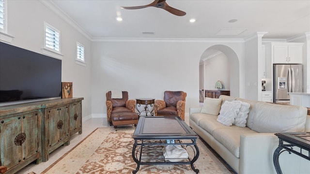 living room featuring arched walkways, recessed lighting, visible vents, ornamental molding, and a ceiling fan