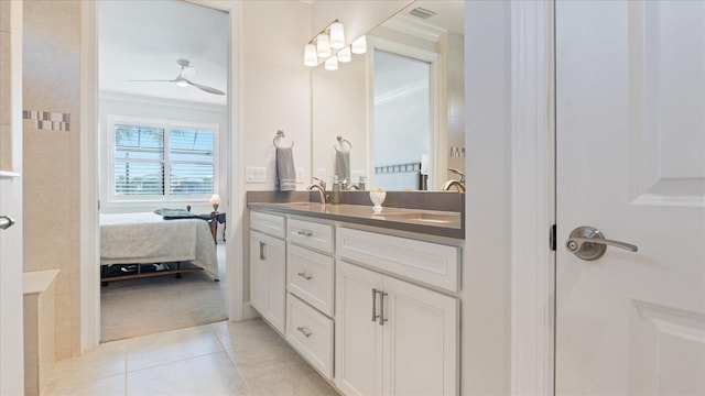 ensuite bathroom featuring double vanity, visible vents, ornamental molding, and a sink