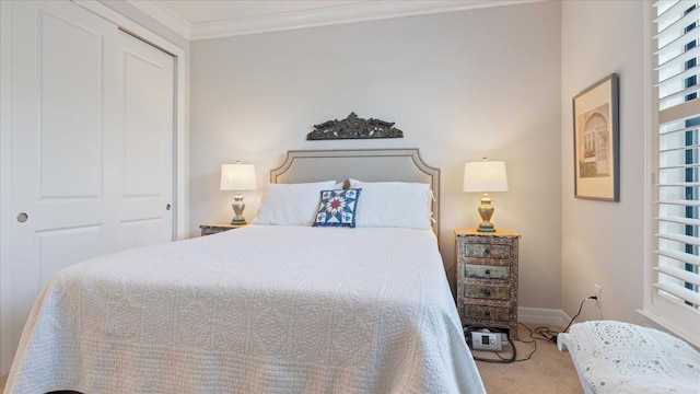 carpeted bedroom featuring a closet, crown molding, and baseboards