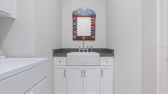 bathroom with washer / clothes dryer and vanity