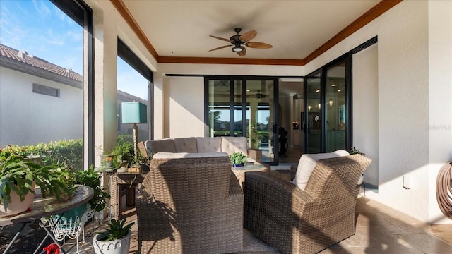 sunroom with a healthy amount of sunlight, visible vents, and a ceiling fan