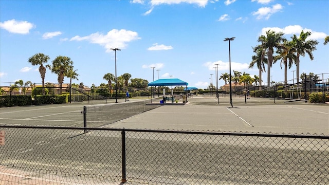 view of tennis court featuring fence