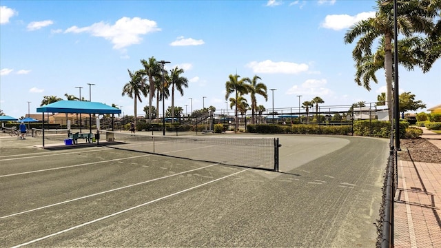 view of tennis court featuring fence