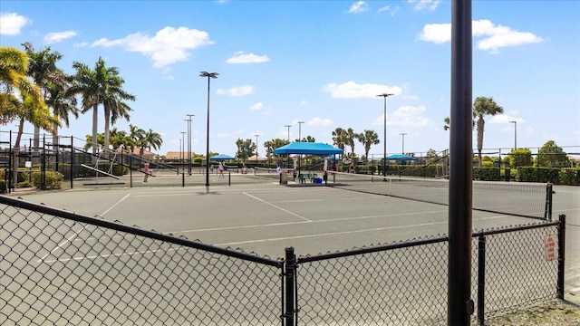 view of tennis court featuring fence