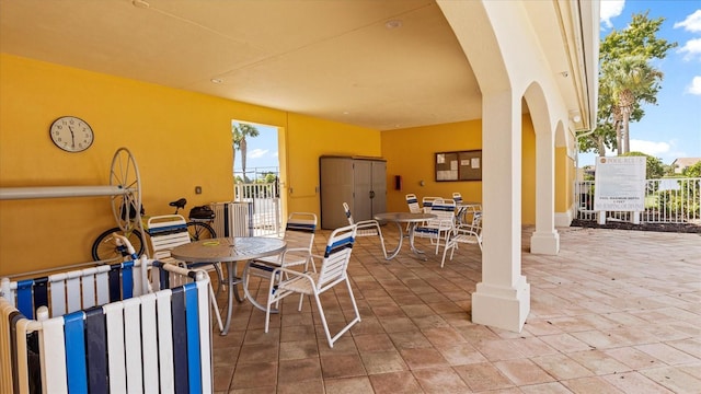 view of patio with outdoor dining space and fence