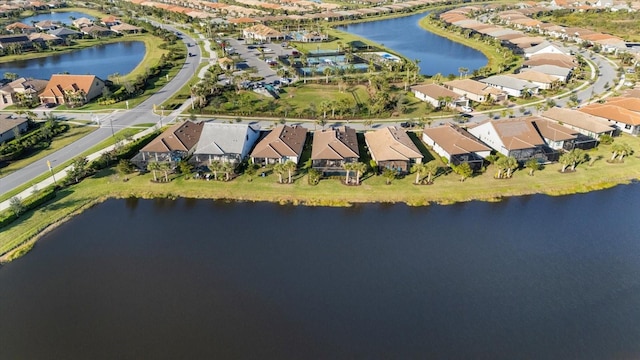 drone / aerial view with a water view and a residential view