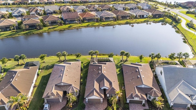 bird's eye view with a residential view and a water view