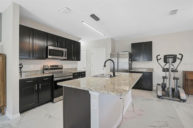 kitchen with a center island with sink, visible vents, appliances with stainless steel finishes, marble finish floor, and a sink