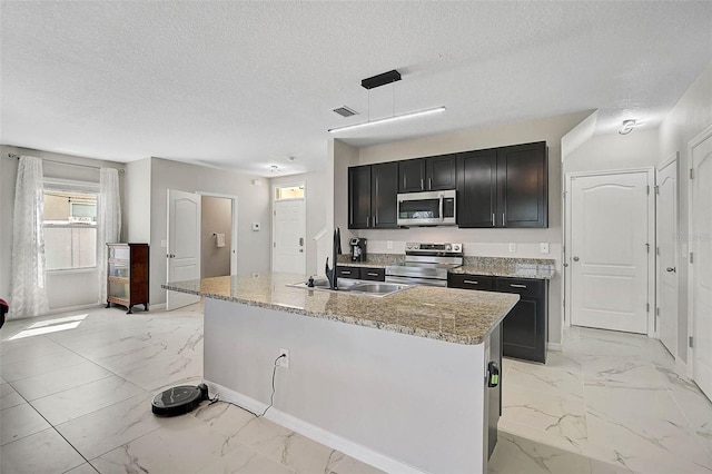 kitchen featuring marble finish floor, stainless steel appliances, a sink, and visible vents