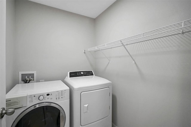 clothes washing area featuring laundry area and washer and dryer