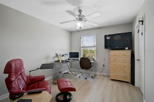 office space featuring baseboards, a ceiling fan, and wood finished floors