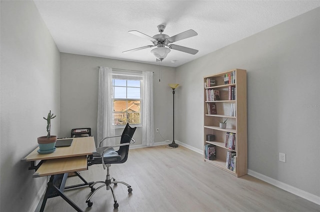 office with a ceiling fan, a textured ceiling, baseboards, and wood finished floors