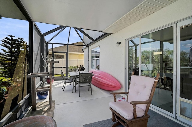 view of patio with a lanai and outdoor dining space