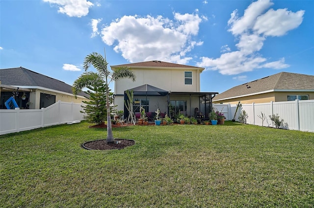 back of house featuring a fenced backyard, a lawn, and stucco siding