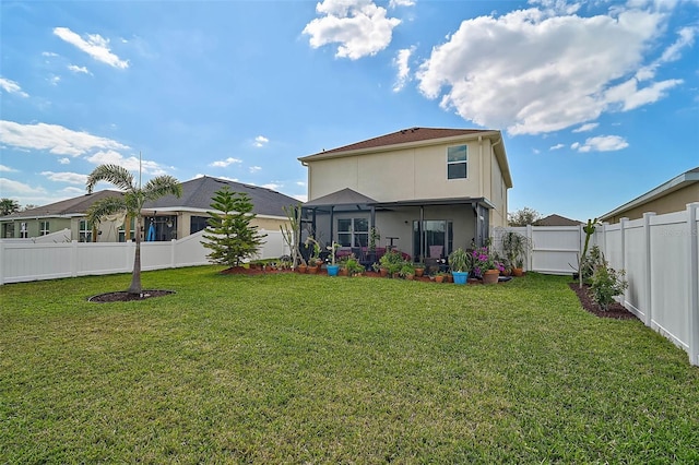 back of house featuring a fenced backyard, a lawn, and stucco siding