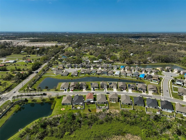 drone / aerial view featuring a water view and a residential view