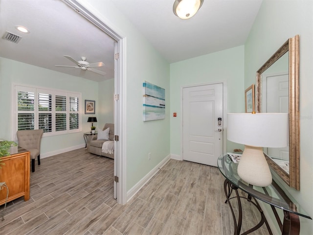 foyer with visible vents, baseboards, and light wood-style floors