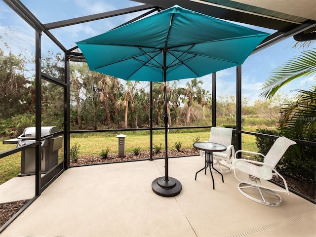 view of patio / terrace featuring area for grilling and glass enclosure