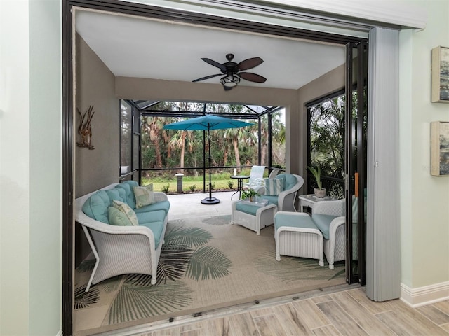 sunroom featuring a ceiling fan