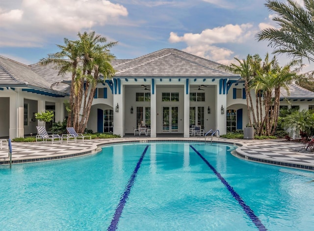 pool with french doors, ceiling fan, and a patio area