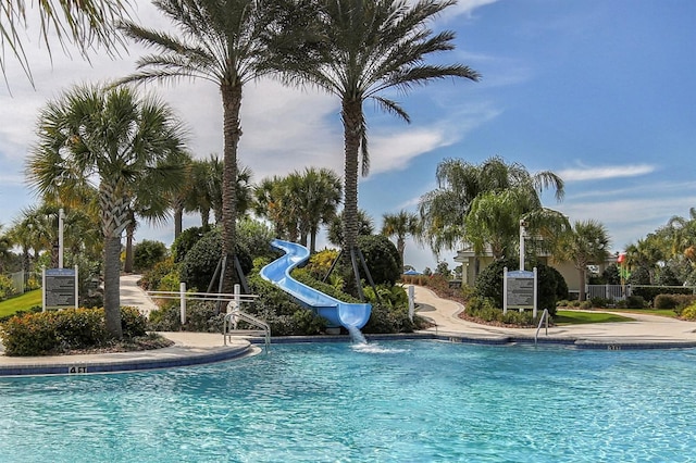 pool with a water slide and fence