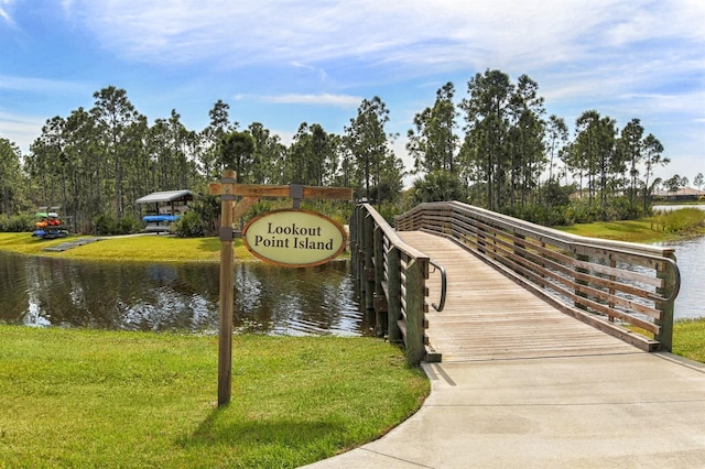 view of home's community featuring a water view and a lawn